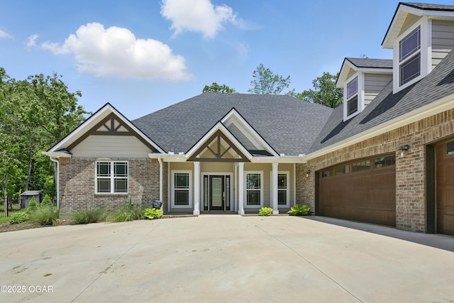 216 Timber Trail Dr, Joplin, MO 64804 - view of front of home with brick siding, driveway, a garage, and roof with shingles