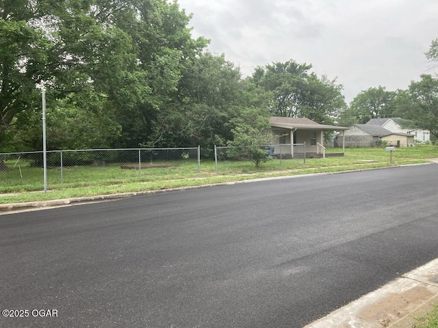 205 S Mccoy Ave, Joplin, MO 64801 - view of asphalt street with curbs and view of wooded area