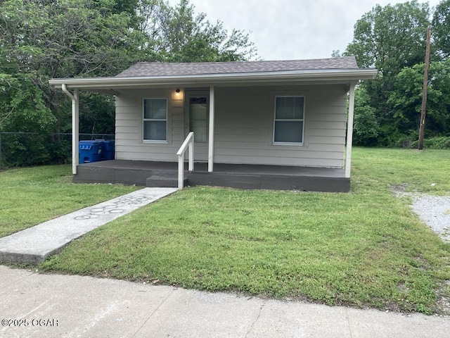 205 S Mccoy Ave, Joplin, MO 64801 - bungalow with a porch, a shingled roof, and a front yard
