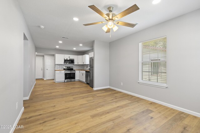 504 S Mckinley Ave, Joplin, MO 64801 - unfurnished living room featuring recessed lighting, baseboards, light wood-style flooring, and ceiling fan