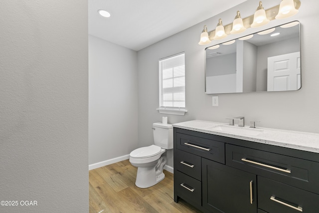 504 S Mckinley Ave, Joplin, MO 64801 - bathroom with vanity, wood finished floors, toilet, and baseboards