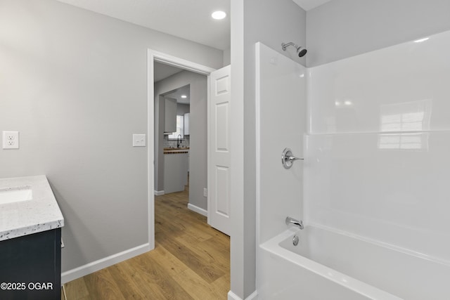 504 S Mckinley Ave, Joplin, MO 64801 - bathroom with wood finished floors, vanity, bathtub / shower combination, and baseboards