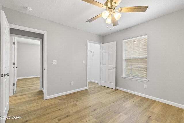 504 S Mckinley Ave, Joplin, MO 64801 - unfurnished bedroom with light wood-style floors, baseboards, and ceiling fan