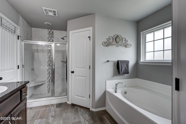 1692 Betenbough Way, Webb City, MO 64870 - bathroom with a garden tub, vanity, a marble finish shower, and wood finished floors