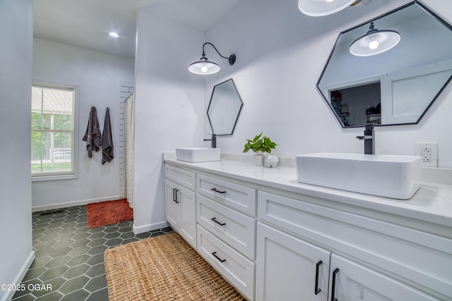 2010 Cherry St, Seneca, MO 64865 - bathroom featuring double vanity, baseboards, recessed lighting, and tile patterned floors