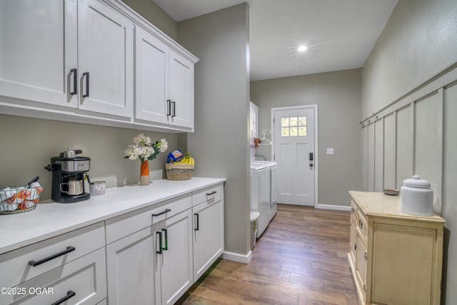 2010 Cherry St, Seneca, MO 64865 - washroom with independent washer and dryer, cabinet space, wood finished floors, baseboards, and recessed lighting