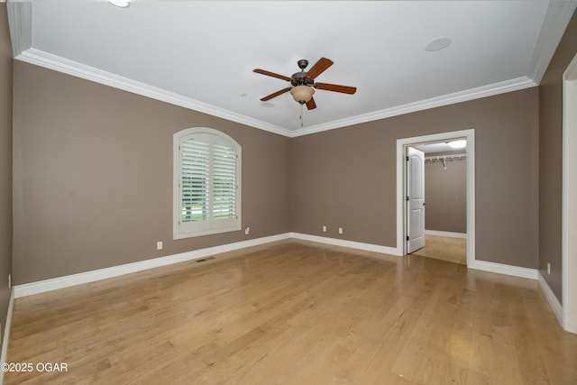 1704 Liam St, Carthage, MO 64836 - spare room with a ceiling fan, baseboards, light wood-style flooring, and ornamental molding