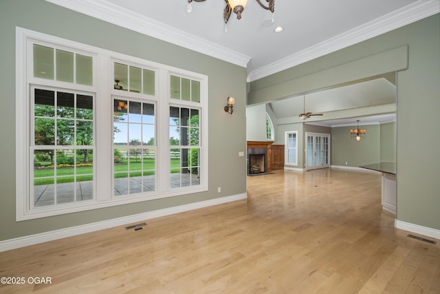 1704 Liam St, Carthage, MO 64836 - unfurnished living room featuring a chandelier, baseboards, a fireplace, ornamental molding, and light wood-style floors