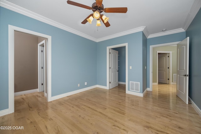 1704 Liam St, Carthage, MO 64836 - unfurnished bedroom with crown molding, light wood-type flooring, baseboards, a walk in closet, and ceiling fan