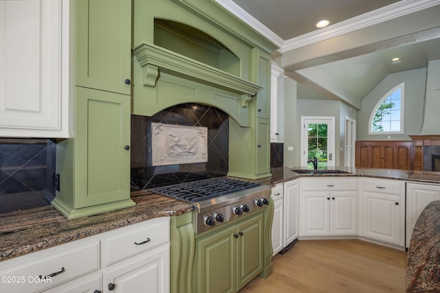 1704 Liam St, Carthage, MO 64836 - kitchen with a sink, dark stone counters, backsplash, white cabinetry, and recessed lighting