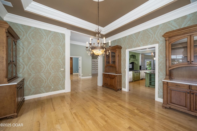 1704 Liam St, Carthage, MO 64836 - unfurnished dining area with wallpapered walls, a chandelier, ornamental molding, light wood-type flooring, and baseboards