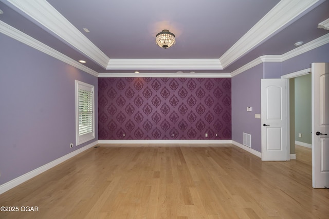 1704 Liam St, Carthage, MO 64836 - unfurnished room featuring baseboards, a tray ceiling, light wood-style floors, and crown molding