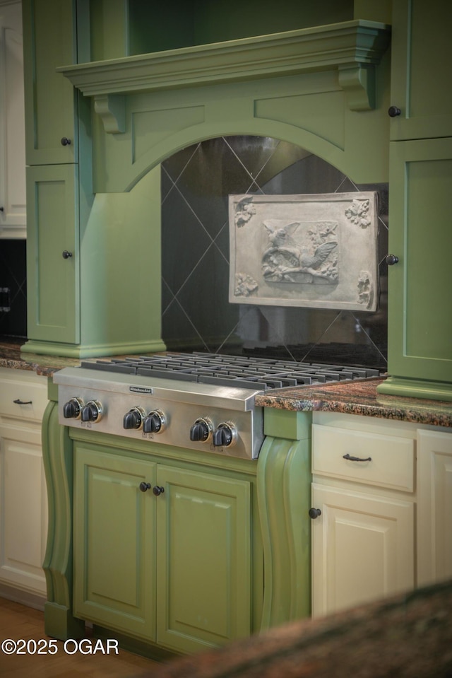 1704 Liam St, Carthage, MO 64836 - kitchen featuring green cabinetry, tasteful backsplash, and dark stone counters