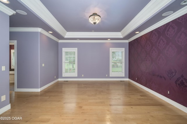 1704 Liam St, Carthage, MO 64836 - empty room with a raised ceiling, light wood-style floors, ornamental molding, and baseboards