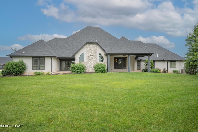 1704 Liam St, Carthage, MO 64836 - view of front of property with a front yard, stone siding, stucco siding, and a shingled roof