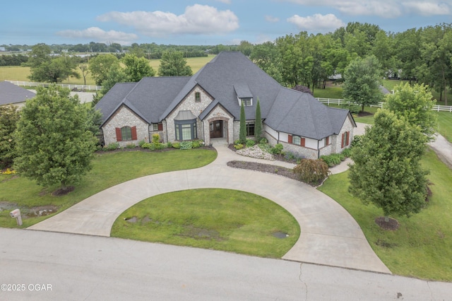 1704 Liam St, Carthage, MO 64836 - french provincial home with stone siding, a front lawn, and curved driveway