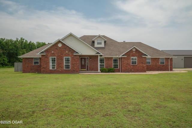 201 Canary Ln, Commerce, OK 74339 - traditional-style house with a front lawn, brick siding, and roof with shingles