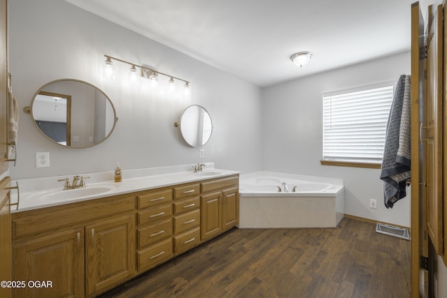 201 Canary Ln, Commerce, OK 74339 - bathroom with double vanity, wood finished floors, and a garden tub