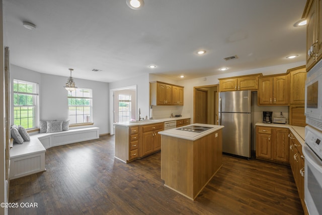 201 Canary Ln, Commerce, OK 74339 - kitchen featuring freestanding refrigerator, oven, healthy amount of natural light, light countertops, and recessed lighting