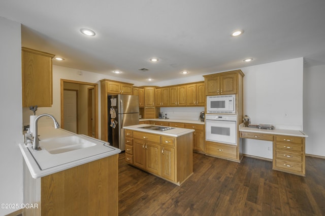 201 Canary Ln, Commerce, OK 74339 - kitchen with white appliances, a sink, light countertops, dark wood finished floors, and recessed lighting