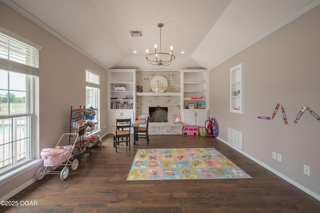 201 Canary Ln, Commerce, OK 74339 - game room with plenty of natural light, vaulted ceiling, a chandelier, built in shelves, and a brick fireplace