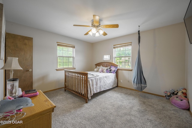 201 Canary Ln, Commerce, OK 74339 - carpeted bedroom with multiple windows, baseboards, and ceiling fan