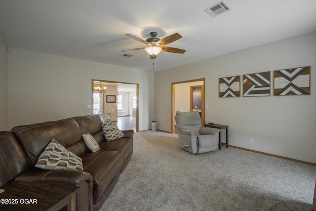 201 Canary Ln, Commerce, OK 74339 - living room featuring a chandelier, carpet floors, a ceiling fan, and baseboards