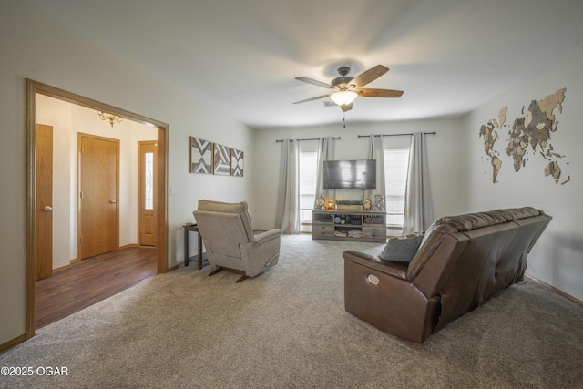 201 Canary Ln, Commerce, OK 74339 - living room with carpet flooring, a ceiling fan, and baseboards
