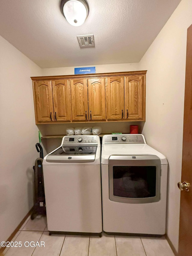 201 Canary Ln, Commerce, OK 74339 - laundry room featuring cabinet space, washer and dryer, light tile patterned floors, and baseboards