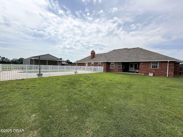 201 Canary Ln, Commerce, OK 74339 - rear view of house featuring brick siding, a chimney, and a patio area