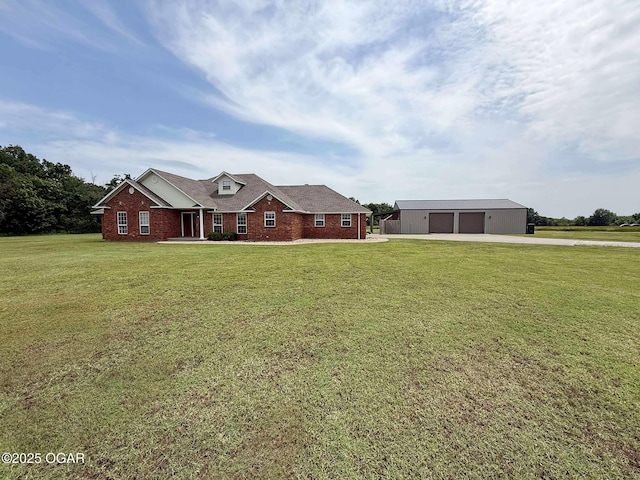 201 Canary Ln, Commerce, OK 74339 - view of front of house featuring an outdoor structure, a detached garage, a front yard, and brick siding