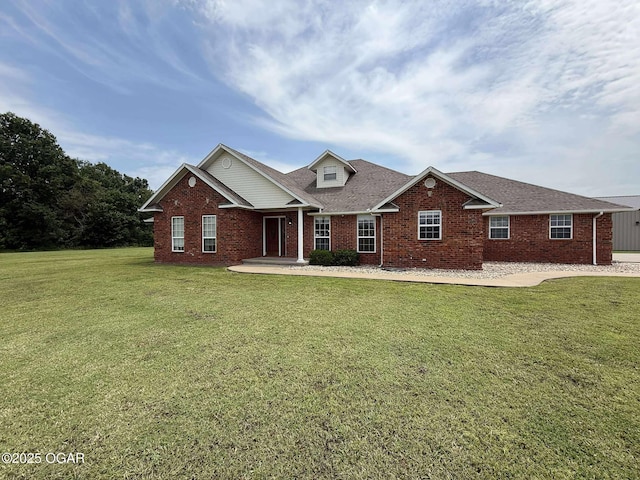201 Canary Ln, Commerce, OK 74339 - traditional-style home featuring brick siding, a front lawn, and roof with shingles