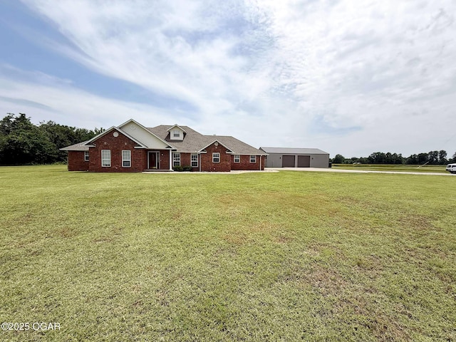 201 Canary Ln, Commerce, OK 74339 - view of front facade with a front lawn, brick siding, driveway, an outdoor structure, and a garage