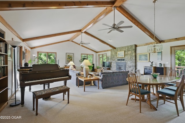 13495 Dogwood Rd, Carthage, MO 64836 - dining area featuring a stone fireplace, light colored carpet, a ceiling fan, and a chandelier