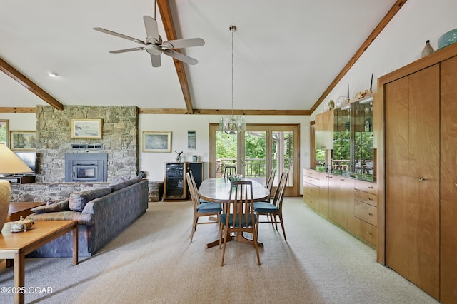 13495 Dogwood Rd, Carthage, MO 64836 - dining room with light carpet, plenty of natural light, a stone fireplace, and ceiling fan
