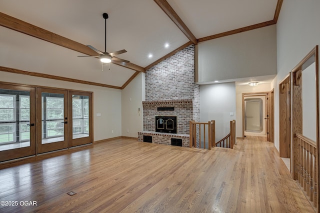 1330 Stoneledge Ln, Neosho, MO 64850 - unfurnished living room featuring ceiling fan, beamed ceiling, light wood-type flooring, high vaulted ceiling, and french doors