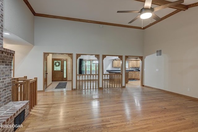 1330 Stoneledge Ln, Neosho, MO 64850 - foyer entrance featuring high vaulted ceiling, light wood finished floors, ceiling fan, baseboards, and crown molding