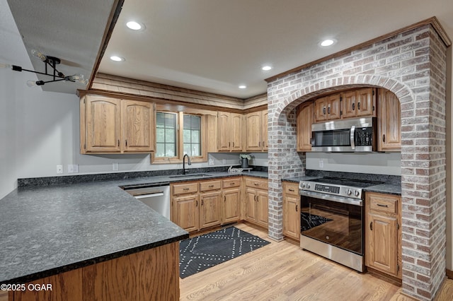1330 Stoneledge Ln, Neosho, MO 64850 - kitchen with stainless steel appliances, light wood-type flooring, dark countertops, recessed lighting, and a sink