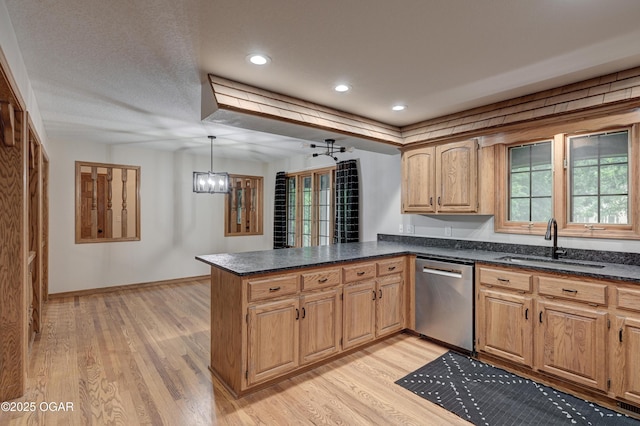 1330 Stoneledge Ln, Neosho, MO 64850 - kitchen with stainless steel dishwasher, a sink, light wood-style flooring, a peninsula, and plenty of natural light