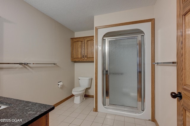 1330 Stoneledge Ln, Neosho, MO 64850 - bathroom with a stall shower, vanity, toilet, tile patterned flooring, and a textured ceiling