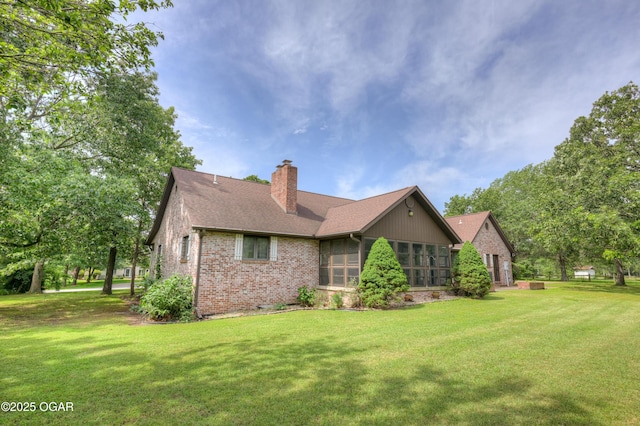 1330 Stoneledge Ln, Neosho, MO 64850 - back of house featuring brick siding, a chimney, a yard, and a sunroom