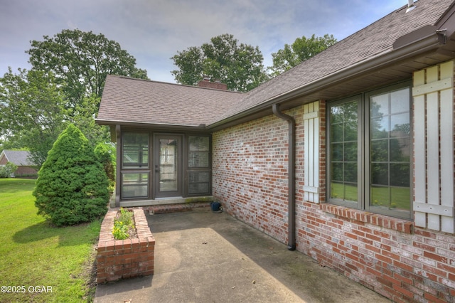 1330 Stoneledge Ln, Neosho, MO 64850 - entrance to property featuring a shingled roof, brick siding, and a chimney