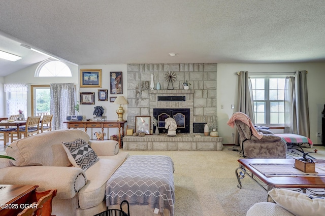 16050 Alford Ln, Diamond, MO 64840 - carpeted living room with a textured ceiling, healthy amount of natural light, a fireplace, and vaulted ceiling