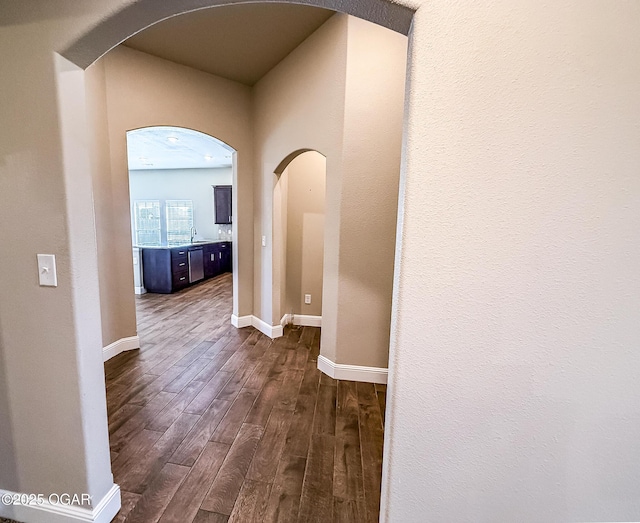 815 Delaney Dr, Carl Junction, MO 64834 - hallway with arched walkways and dark wood-style flooring