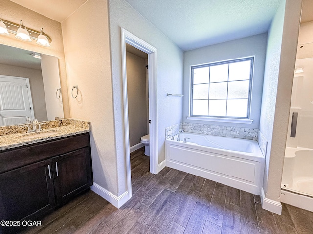 815 Delaney Dr, Carl Junction, MO 64834 - bathroom featuring wood finished floors, vanity, and a bath