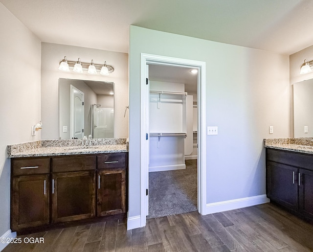 815 Delaney Dr, Carl Junction, MO 64834 - full bath featuring wood finished floors, a spacious closet, two vanities, and a stall shower