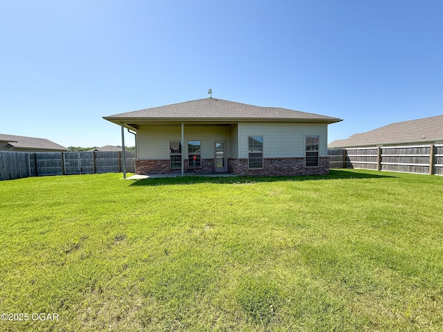 815 Delaney Dr, Carl Junction, MO 64834 - back of property featuring brick siding and a fenced backyard