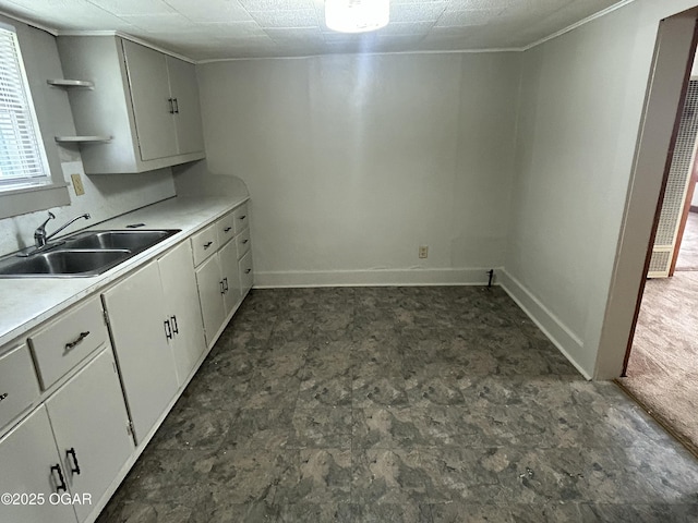 421 N Webb St, Webb City, MO 64870 - kitchen with a sink, dark flooring, open shelves, light countertops, and baseboards