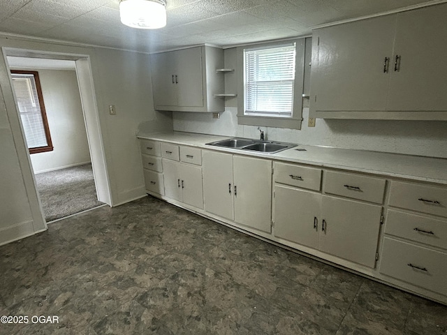 421 N Webb St, Webb City, MO 64870 - kitchen with a sink, dark floors, light countertops, and white cabinets