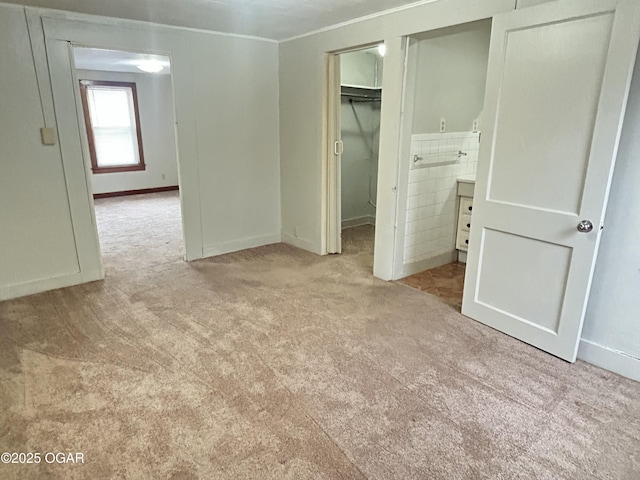 421 N Webb St, Webb City, MO 64870 - unfurnished bedroom with carpet flooring, a walk in closet, crown molding, a closet, and baseboards